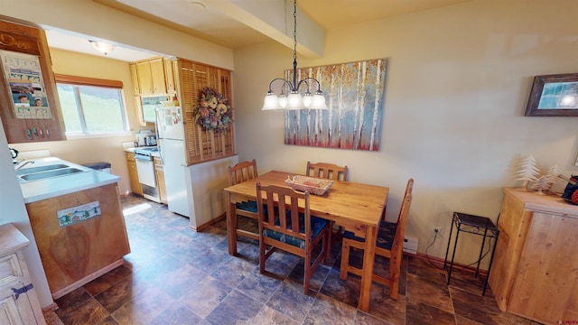 dining room with a notable chandelier and sink