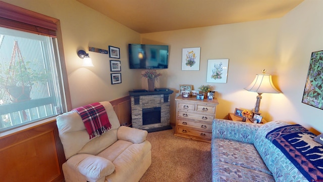 living room with a fireplace and carpet floors