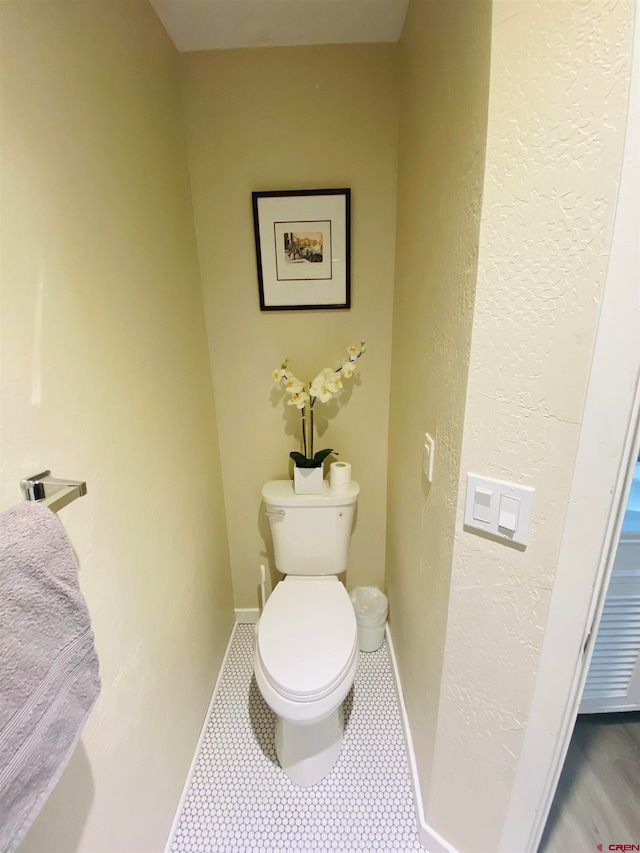 bathroom with tile flooring and toilet