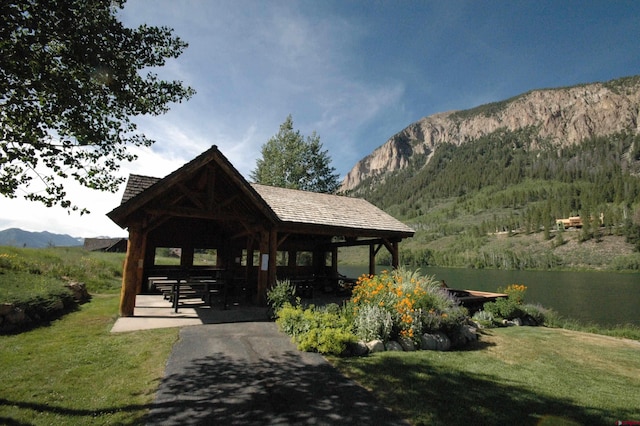 view of property's community with a gazebo, a mountain view, and a yard