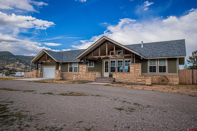 view of front of property with a mountain view and a garage