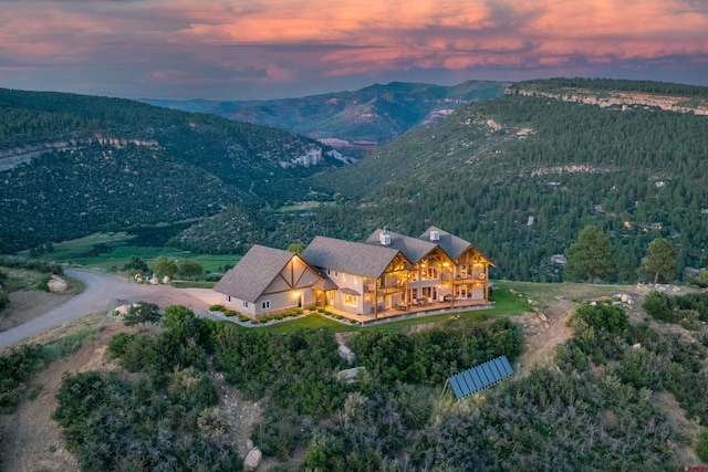 aerial view at dusk featuring a mountain view