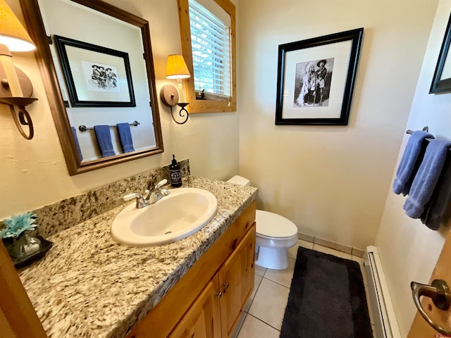 bathroom featuring tile flooring, toilet, vanity, and a baseboard heating unit