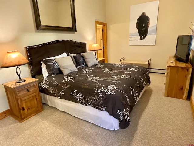 bedroom featuring light carpet and a baseboard radiator