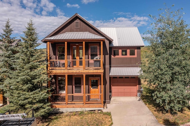 view of front of house with a balcony, covered porch, and a garage