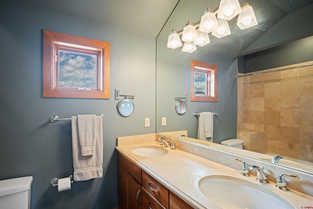 bathroom with oversized vanity, dual sinks, and toilet