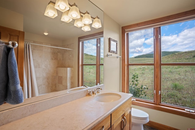 full bathroom with shower / bath combo with shower curtain, toilet, and vanity with extensive cabinet space