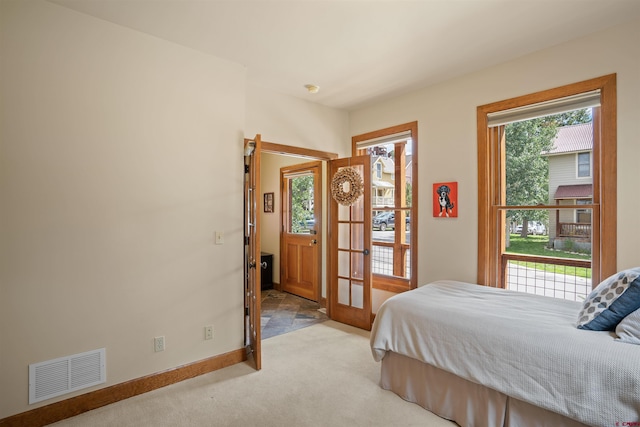 carpeted bedroom with french doors