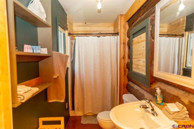 289 S Main St, Creede, CO 81130 - bathroom with toilet, wood finished floors, a sink, and a shower with shower curtain
