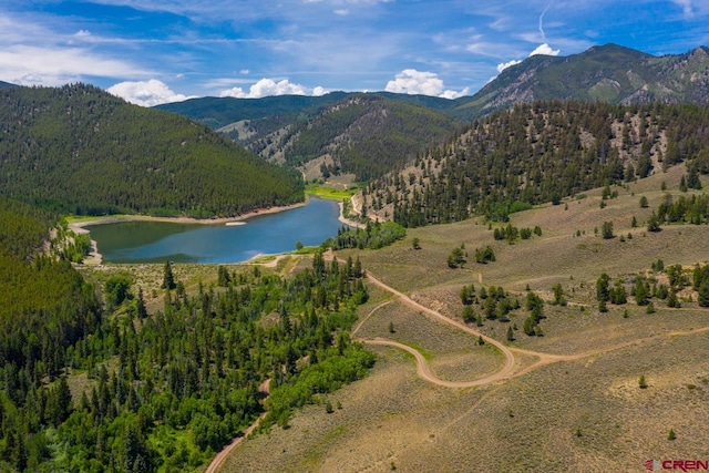 drone / aerial view featuring a water and mountain view