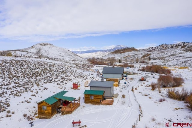 snowy aerial view with a mountain view