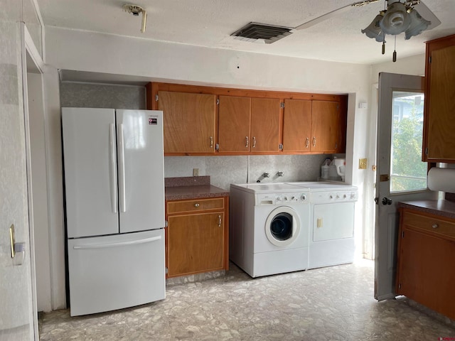 clothes washing area with light tile floors, ceiling fan, cabinets, hookup for a washing machine, and washer and dryer