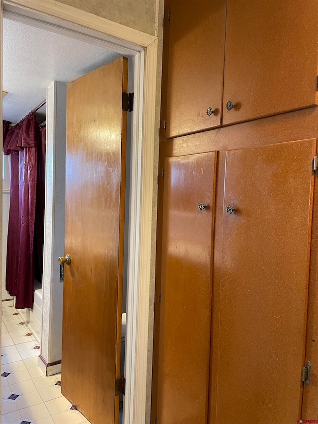 room details featuring light tile floors and a textured ceiling