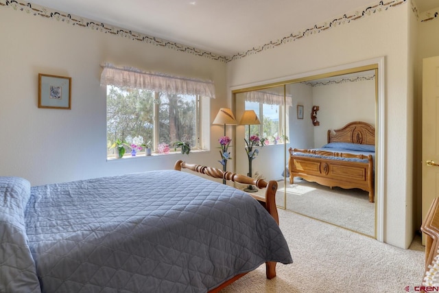 bedroom with a closet and light carpet