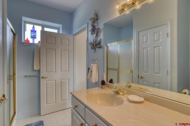 bathroom with tile flooring, a shower with door, and oversized vanity