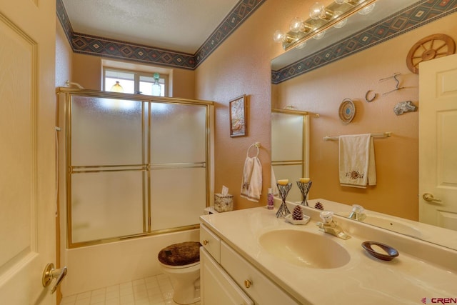 full bathroom featuring toilet, a textured ceiling, enclosed tub / shower combo, vanity with extensive cabinet space, and tile flooring