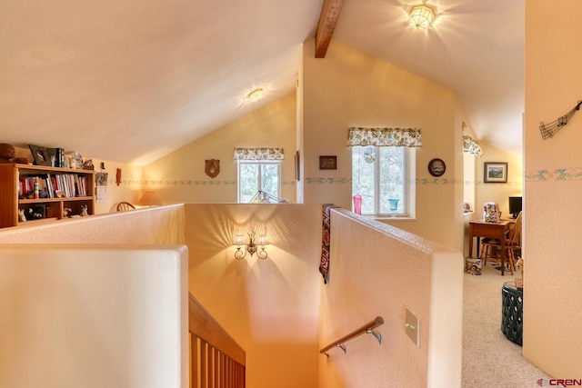 interior space with carpet floors and lofted ceiling with beams