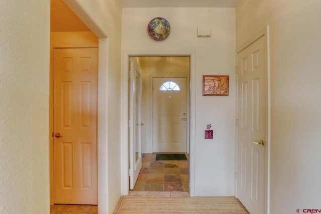 hallway featuring light tile floors