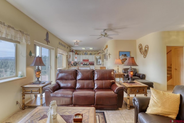 tiled living room featuring ceiling fan