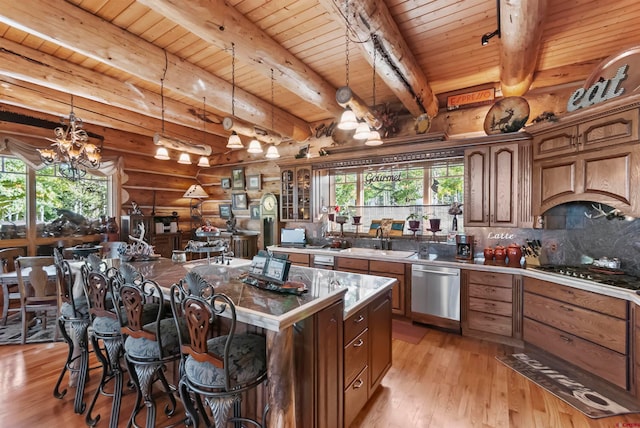 kitchen featuring a center island, beam ceiling, log walls, light hardwood / wood-style flooring, and an inviting chandelier