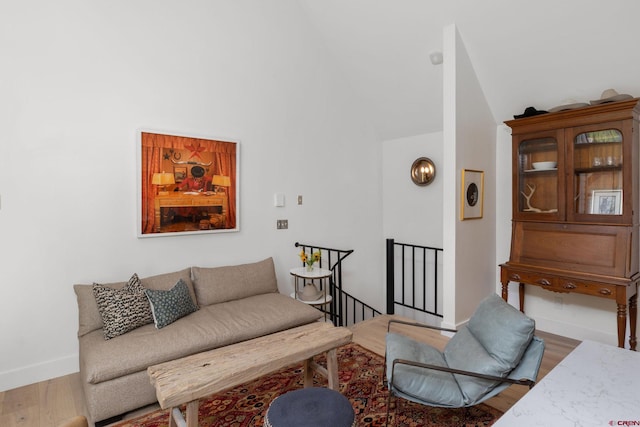 living room featuring hardwood / wood-style floors and vaulted ceiling