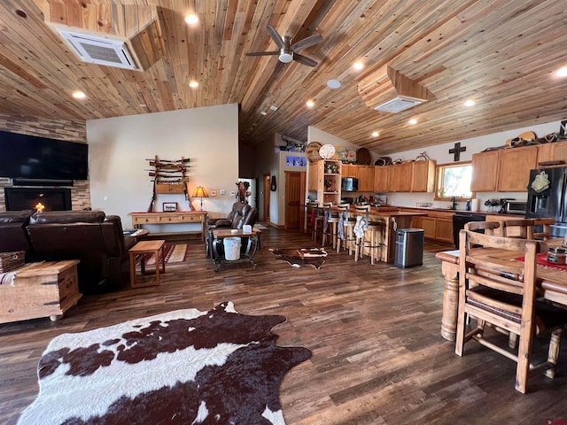 living room with wooden ceiling, ceiling fan, dark wood-type flooring, and a stone fireplace