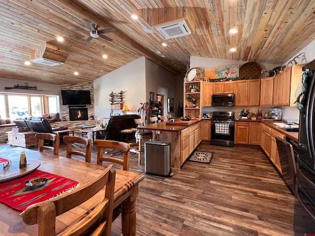 kitchen with dark wood-type flooring, ceiling fan, gas stove, a fireplace, and wood ceiling