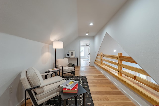 living area with vaulted ceiling and light hardwood / wood-style floors