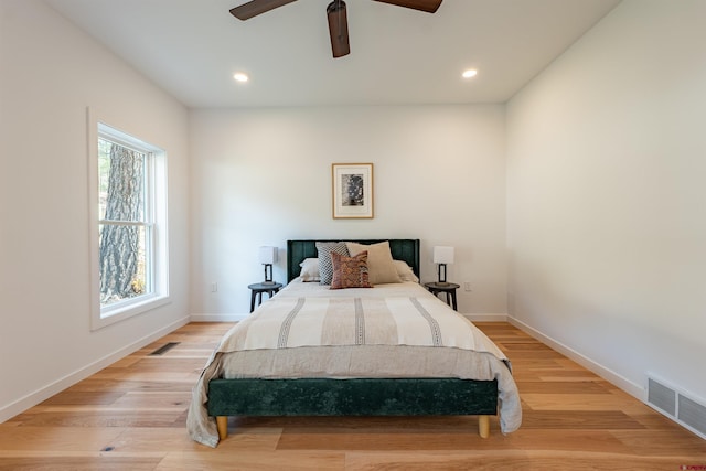 bedroom with ceiling fan and light hardwood / wood-style floors