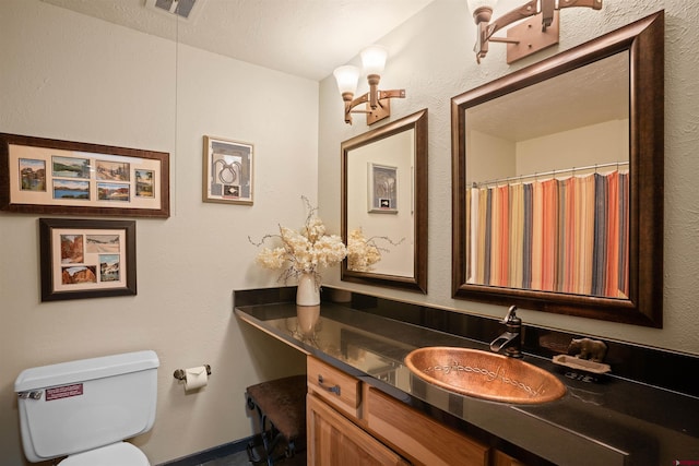 bathroom with toilet and vanity