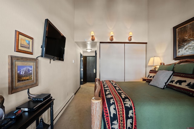 bedroom with a baseboard radiator and light carpet