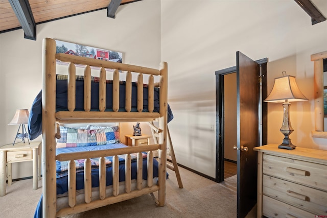 bedroom with vaulted ceiling with beams, dark colored carpet, and wood ceiling