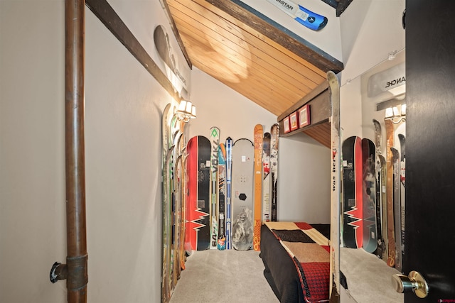 walk in closet with high vaulted ceiling and carpet floors