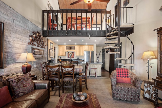 carpeted living room with high vaulted ceiling and ceiling fan