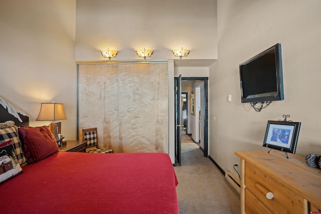 bedroom featuring a baseboard radiator and light colored carpet