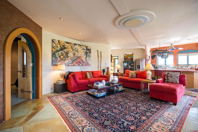 living room featuring light tile floors and an inviting chandelier