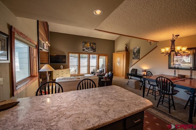 dining space featuring a textured ceiling, dark carpet, lofted ceiling, and a chandelier