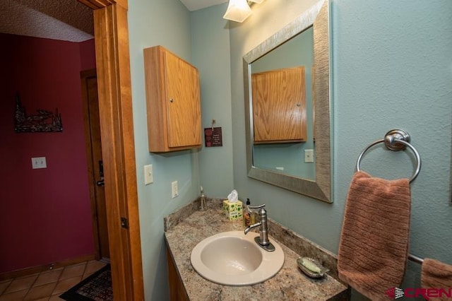 bathroom with large vanity and tile flooring