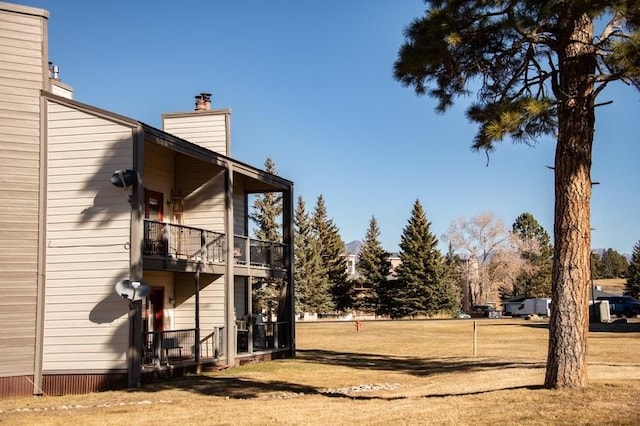 view of side of home featuring a balcony