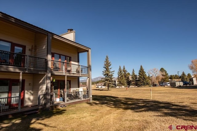 view of yard featuring a balcony