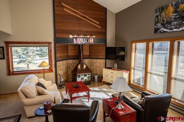 living room featuring high vaulted ceiling, wooden walls, light colored carpet, and a baseboard radiator