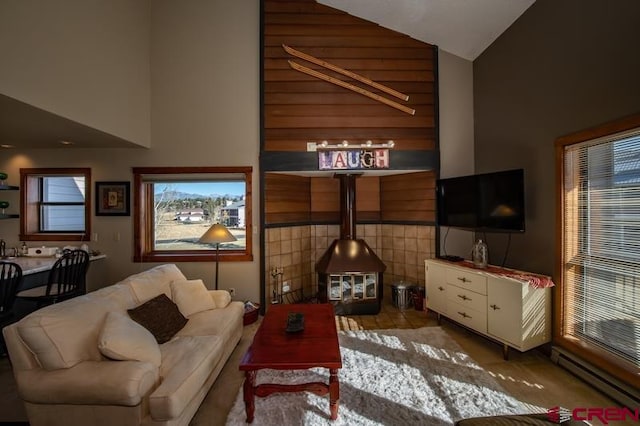 living room featuring a baseboard radiator and high vaulted ceiling