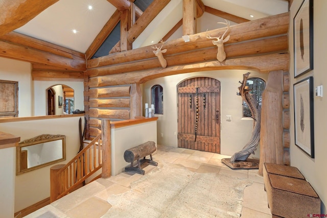 103 Double Eagle Way, Mountain Village, CO 81435 - interior space with light tile floors, rustic walls, high vaulted ceiling, and beamed ceiling