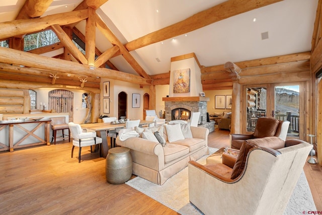 103 Double Eagle Way, Mountain Village, CO 81435 - living room with log walls, high vaulted ceiling, light hardwood / wood-style flooring, a fireplace, and beam ceiling