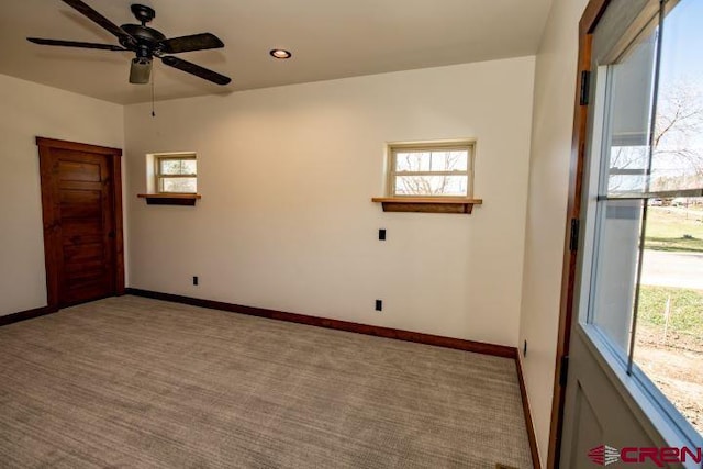 spare room with carpet and ceiling fan