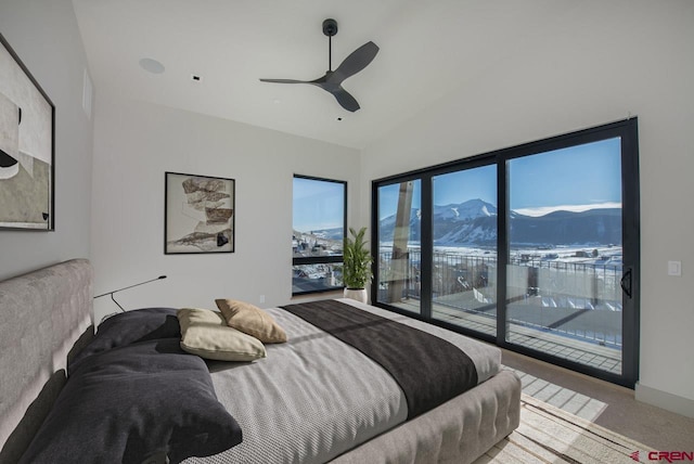 carpeted bedroom featuring lofted ceiling, a mountain view, access to outside, and ceiling fan