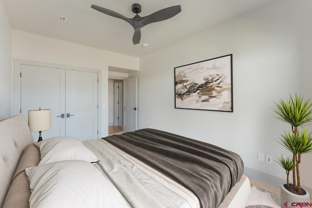 bedroom featuring ceiling fan and a closet