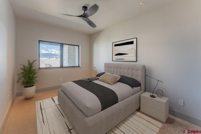 bedroom with light carpet and ceiling fan