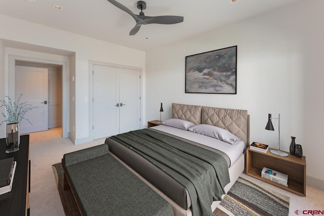 carpeted bedroom featuring a closet and ceiling fan