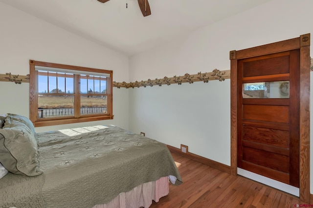 bedroom featuring vaulted ceiling, ceiling fan, and hardwood / wood-style floors